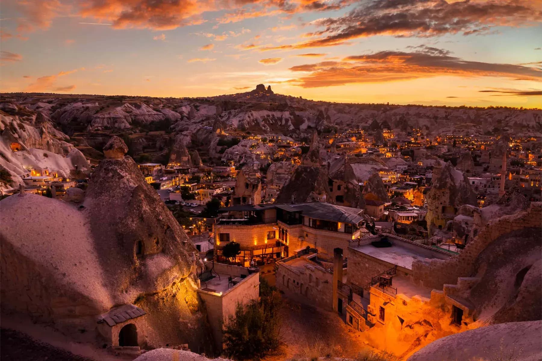 Fiery sunset over the rock-cut houses and valleys of Cappadocia, Turkey
