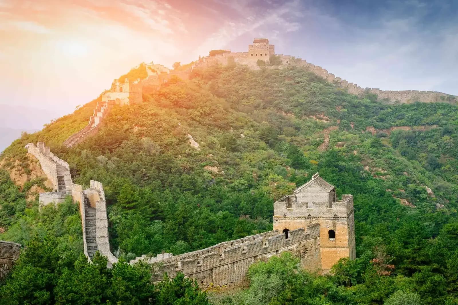 The Great Wall of China snaking along a forested mountain ridge on a private China tour