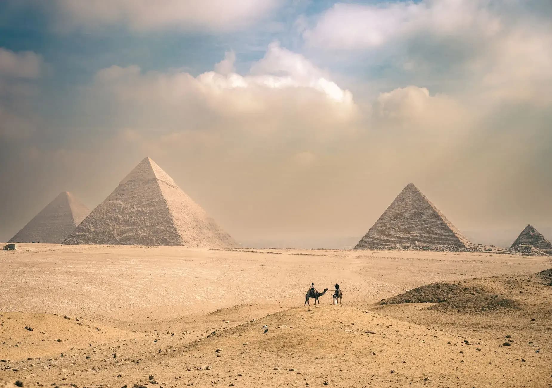 The pyramids of Giza rising above the desert at golden hour on a luxury Africa journey