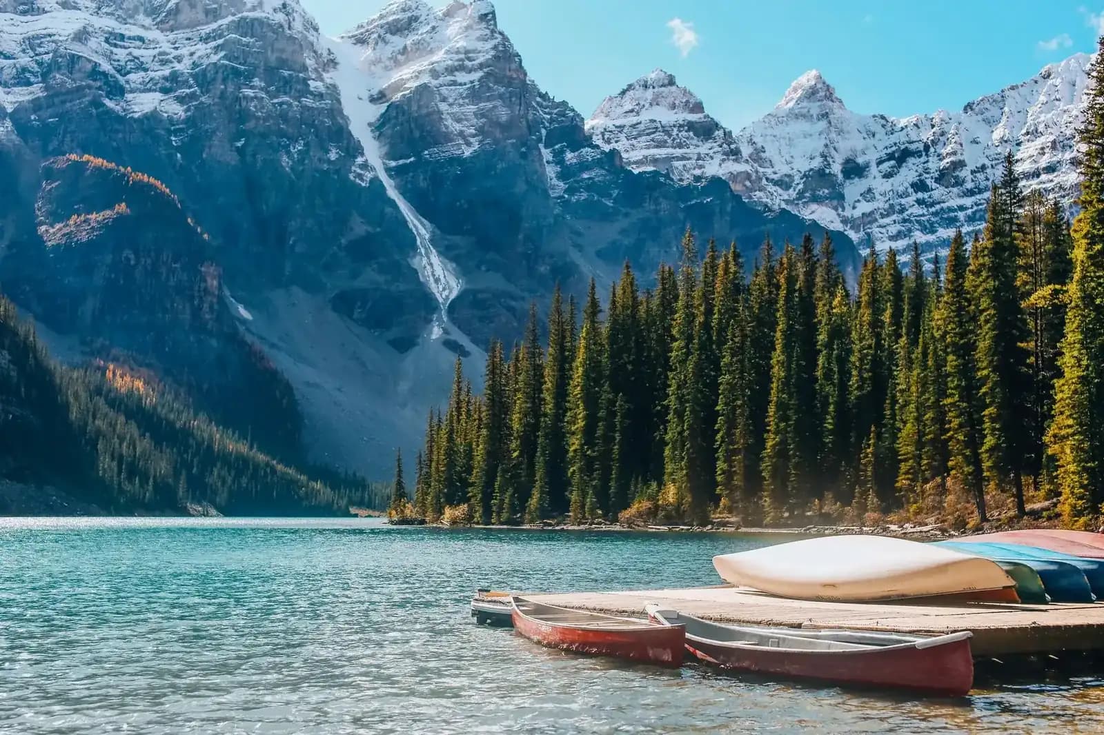 Turquoise alpine lake beneath snow-capped peaks in the Canadian Rockies