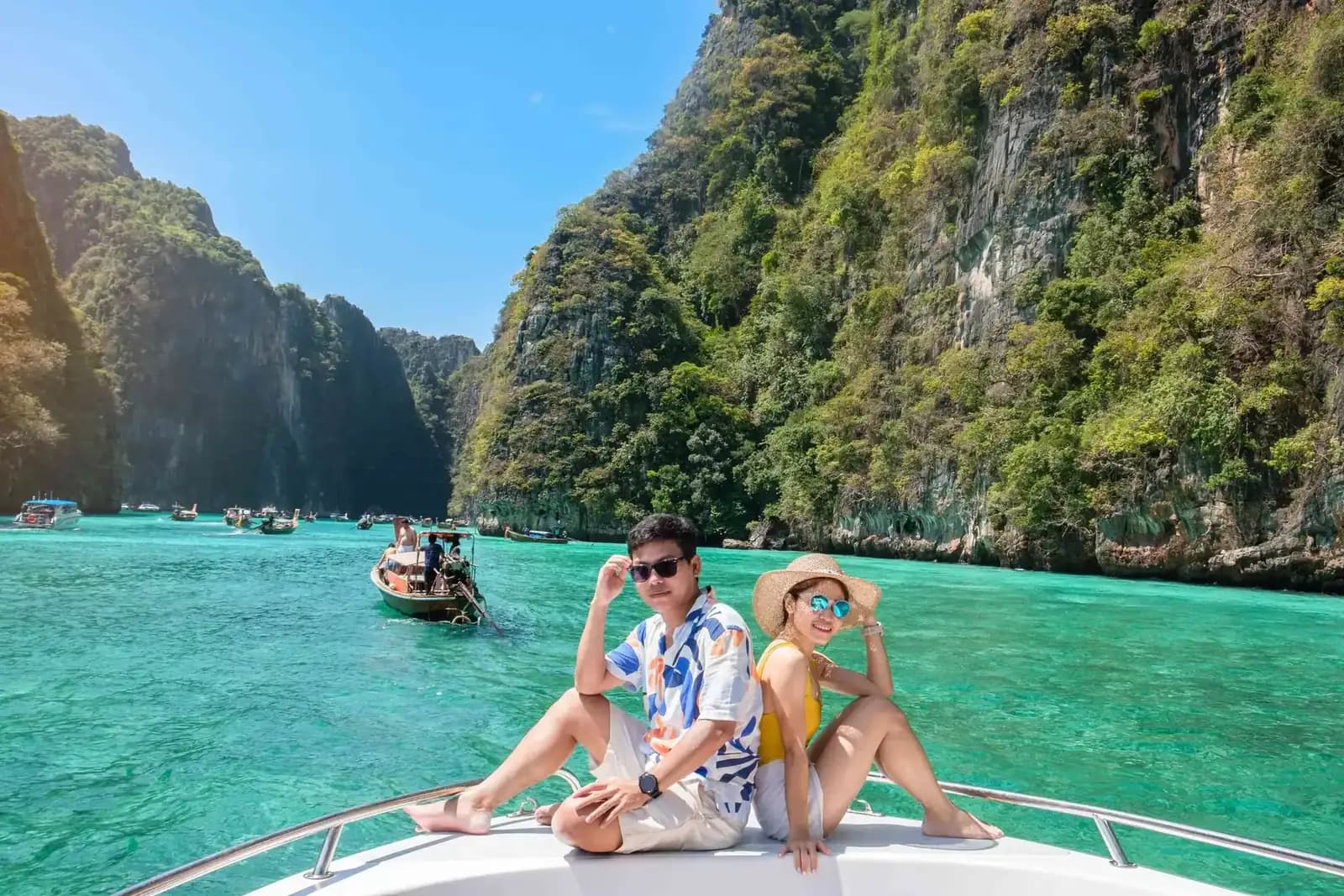 Longtail boat on turquoise water between the limestone cliffs of the Phi Phi Islands, Thailand